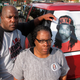 In this Dec. 13, 2013 file photo, Kenneth and Jacquelyn Johnson stand next to a banner on their SUV showing their late son, Kendrick Johnson in Valdosta, Ga. A Georgia sheriff said Wednesday, March 10, 2021, he’s reopened an investigation into the 2013 death of the teenager, whose body was found inside a rolled-up gym mat at his high school.